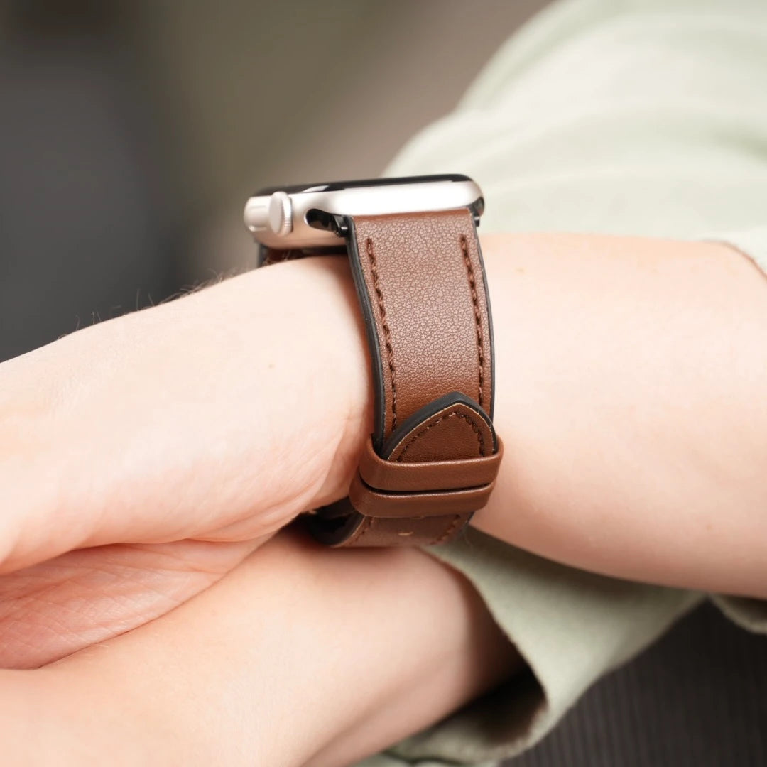 Apple Watch mit klassischem braunen Lederarmband von Breband am Handgelenk getragen. #farbe_braun