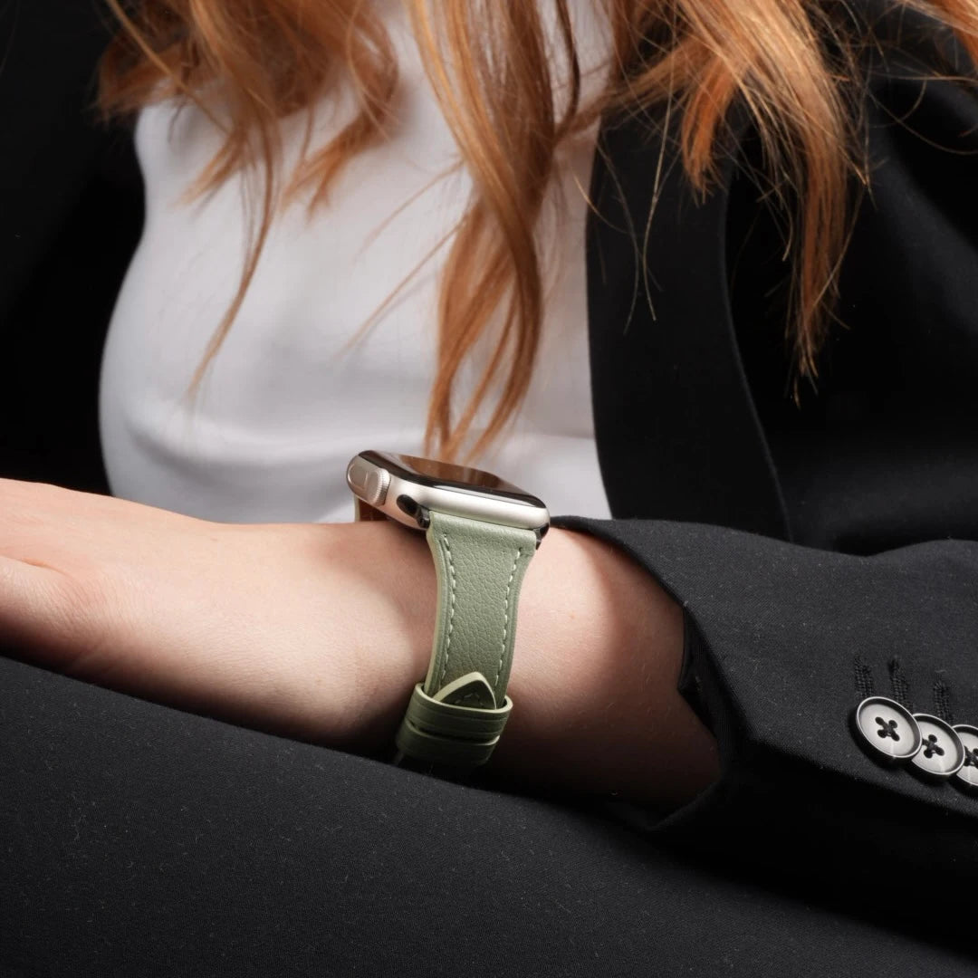 Apple Watch mit lindgrünem Breband Lederarmband am Handgelenk, getragen zu einem hellen Outfit. #farbe_lindgrün